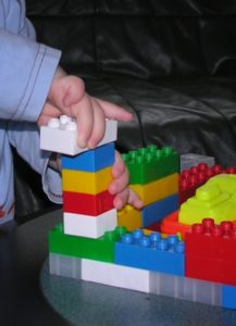 Someone building with Lego bricks