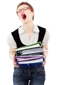 Person overwhelmed by paperwork